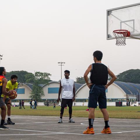 Students playing basketball at the outdoor court