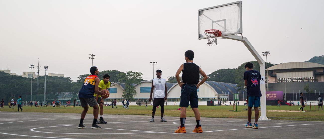 Students playing basketball at the outdoor court