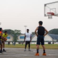 Students playing basketball at the outdoor court