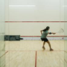 A student playing squash