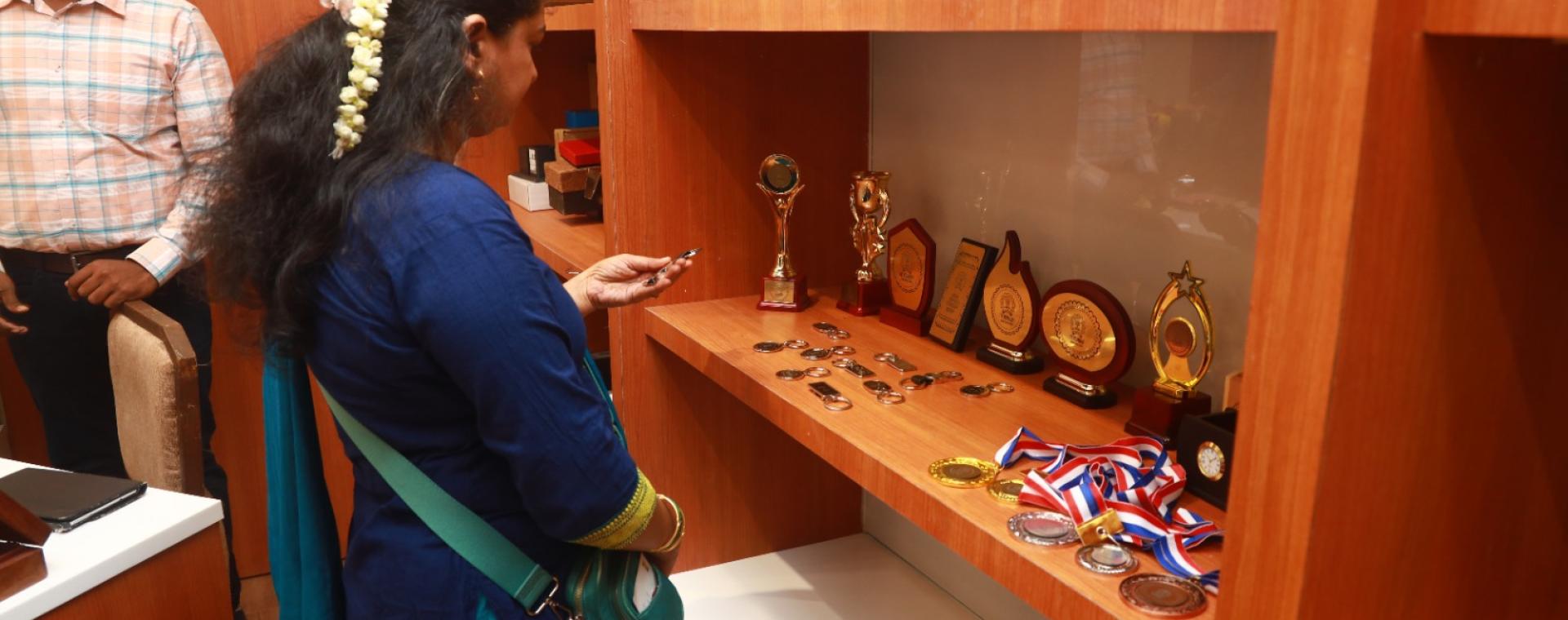 An employee checking out collection of IIT Bombay merchandise at the launch of Institute’s New Souvenir Shop