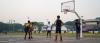 Students playing basketball at the outdoor court